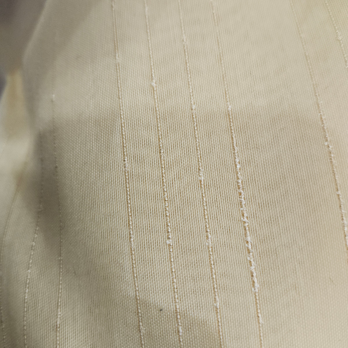 Gold wide-width sheer polyester drapery fabric with a textured finish