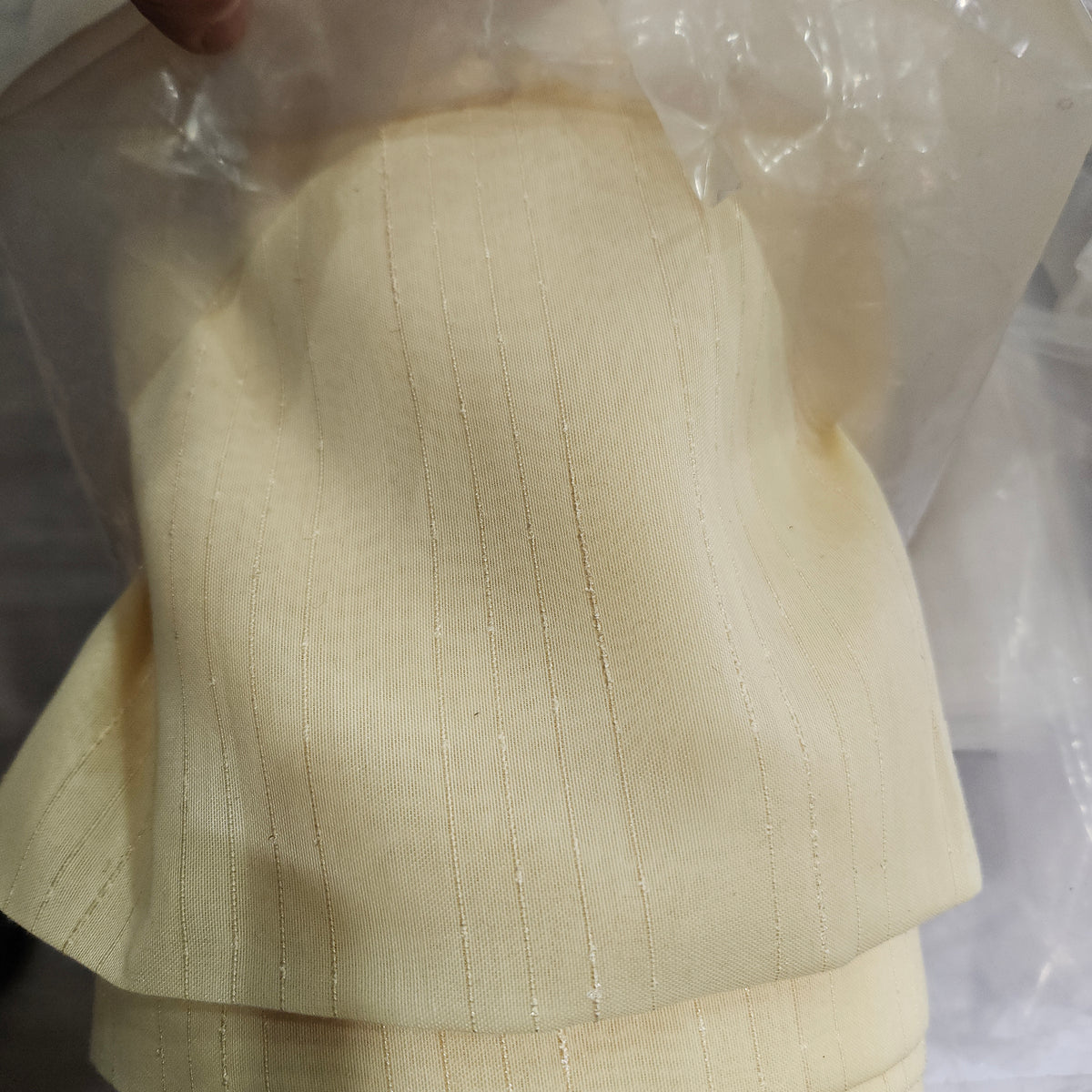 Gold wide-width sheer polyester drapery fabric with a textured finish